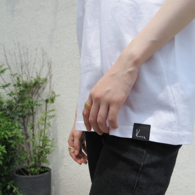 the model is wearing the white t-shirt