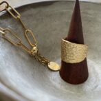 the gold ring and the gold bracelet on the ceramic plate