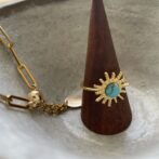 gold ring with the turquoise stone and the gold chain bracelet