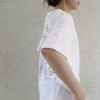 the model is wearing a white shirt